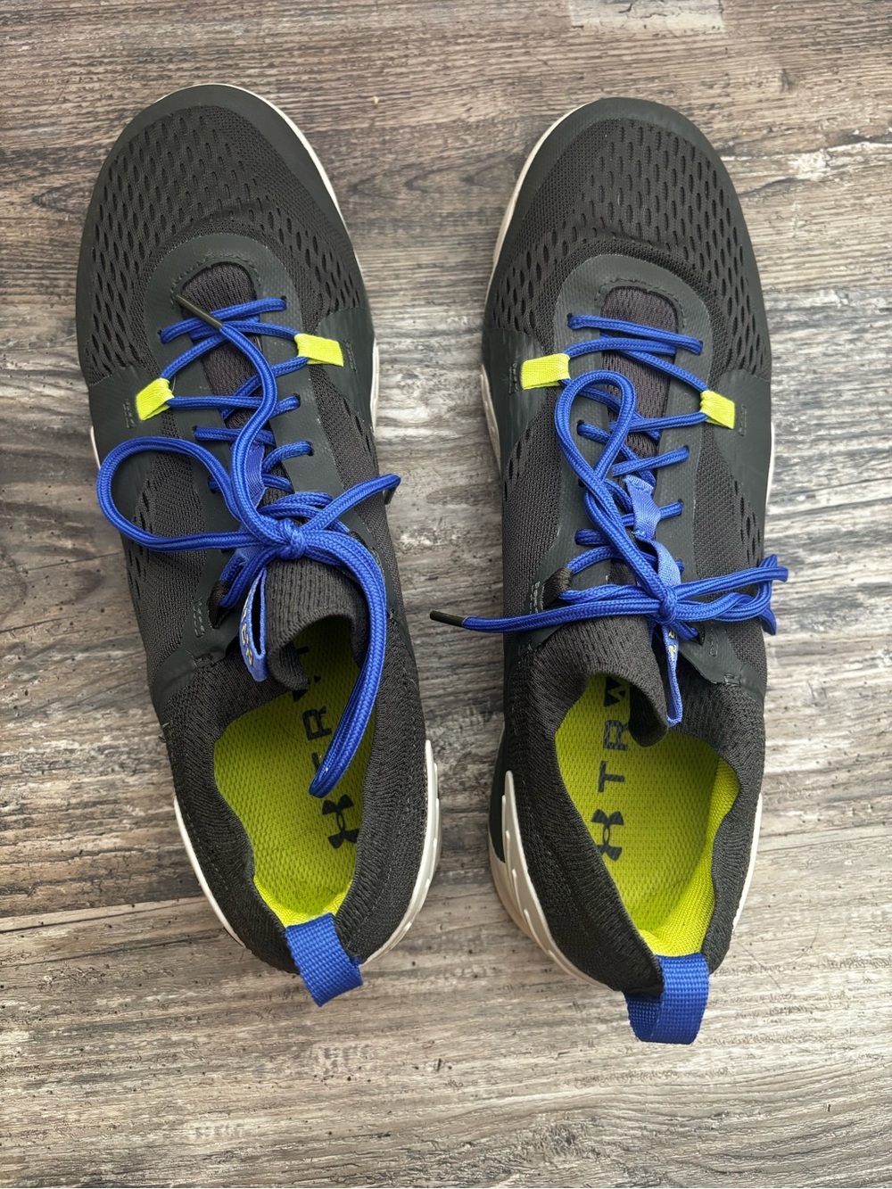 Under Armour Men’s Dark grey Athletic Shoes with Blue Laces and Neon Yellow.